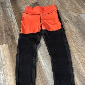 Orange leggings with black mesh